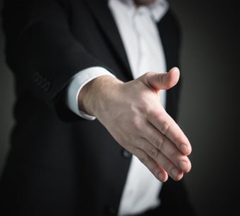 Image of a man extending his hand for a handshake.