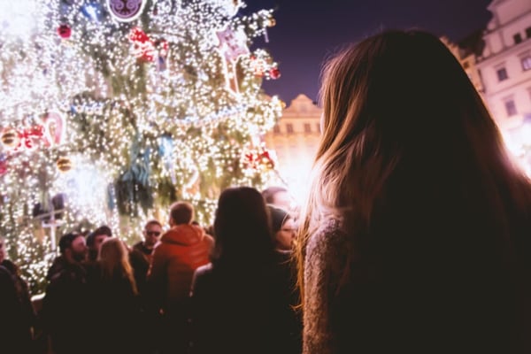 Image of a woman looking at a Christmas tree