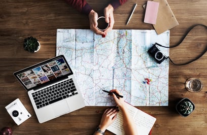 Image of two people planning a route on a map