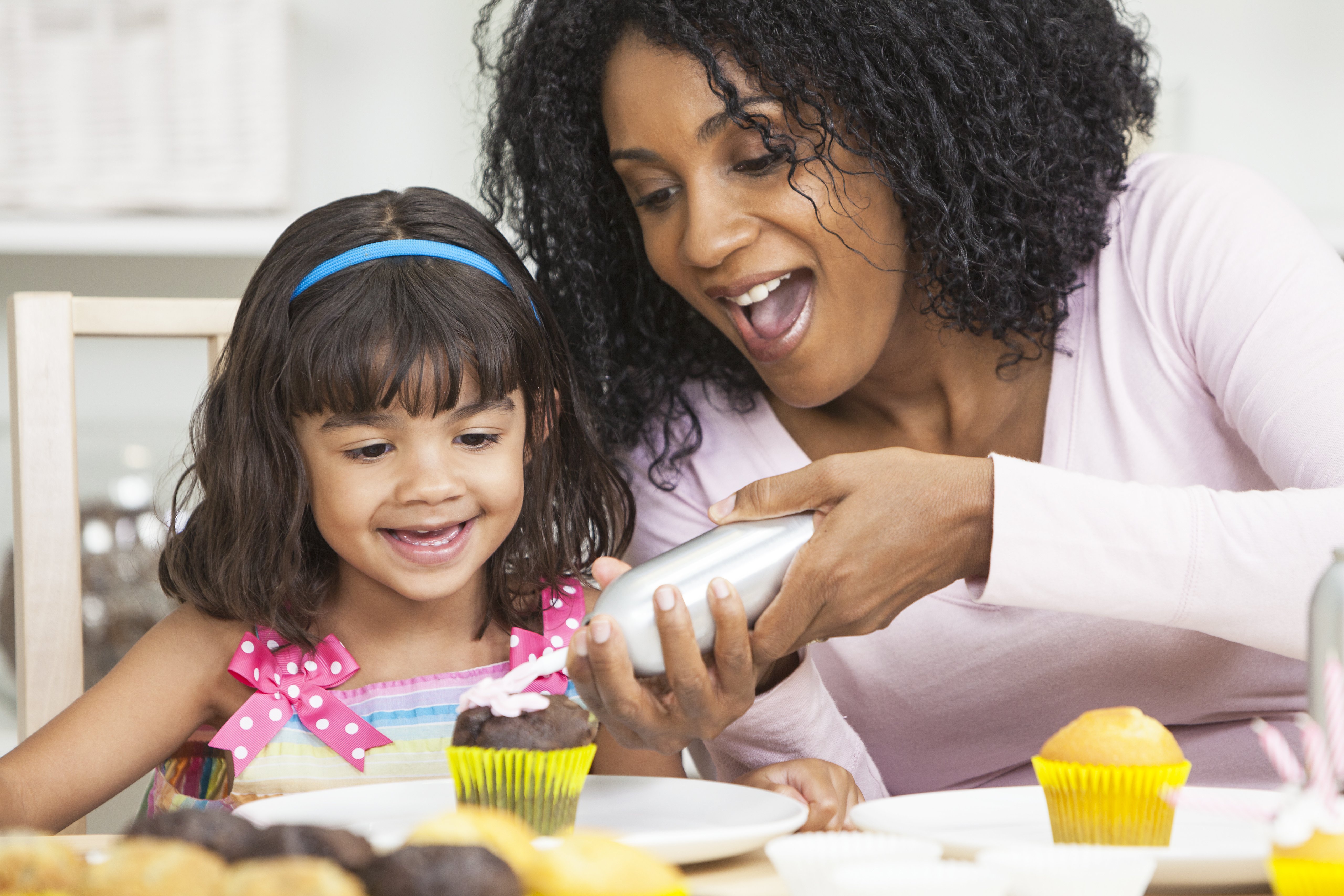 Mother and Daughter Cooking in Kitchen