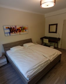 This is an image of a bedroom at the Rue de Kirchberg corporate housing unit.