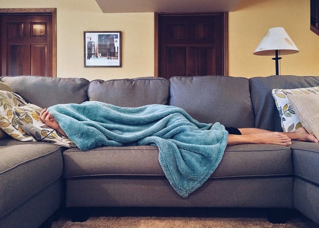 Image of a person sleeping on a couch