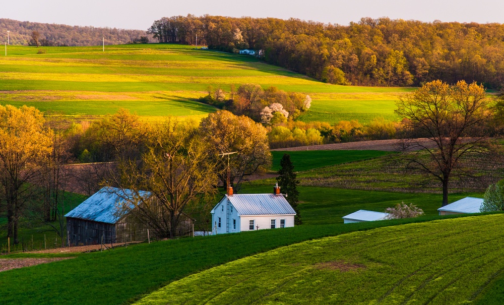 Home and barn on the farm fields and rolling hills of Southern York County, Pennsylvania.