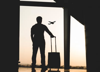 Image of a person with a suitcase