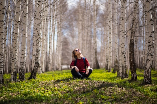 Image of a young lady sitting in the forest