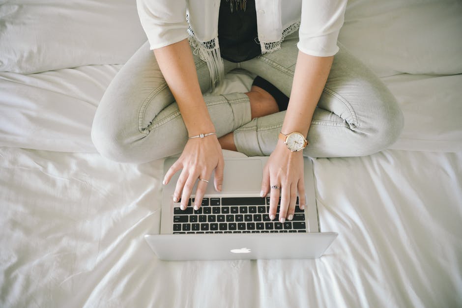 Image of a woman using an Apple laptop.