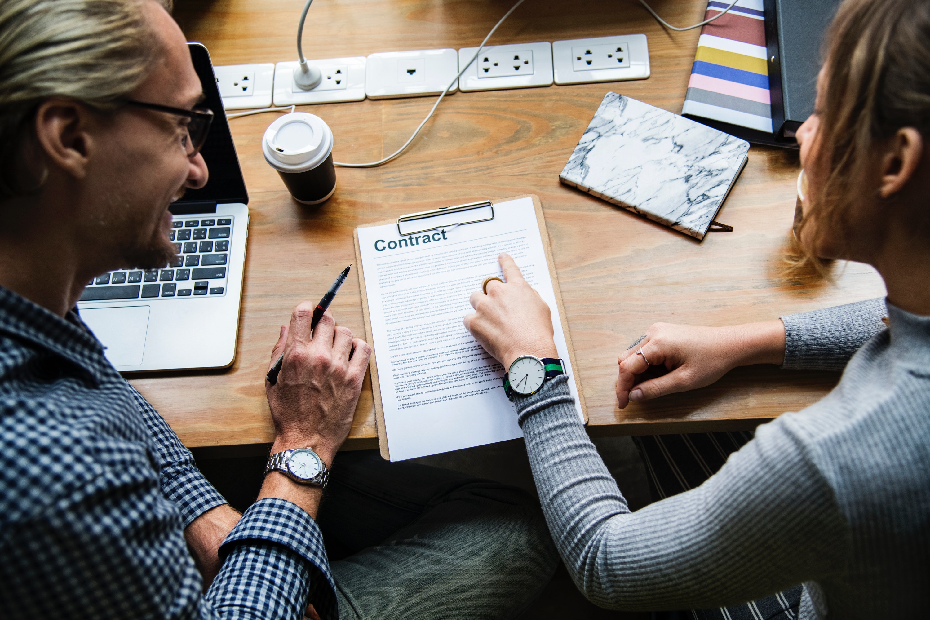 photo of a man and woman reviewing a contract