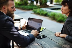 Image of two people having a discussion