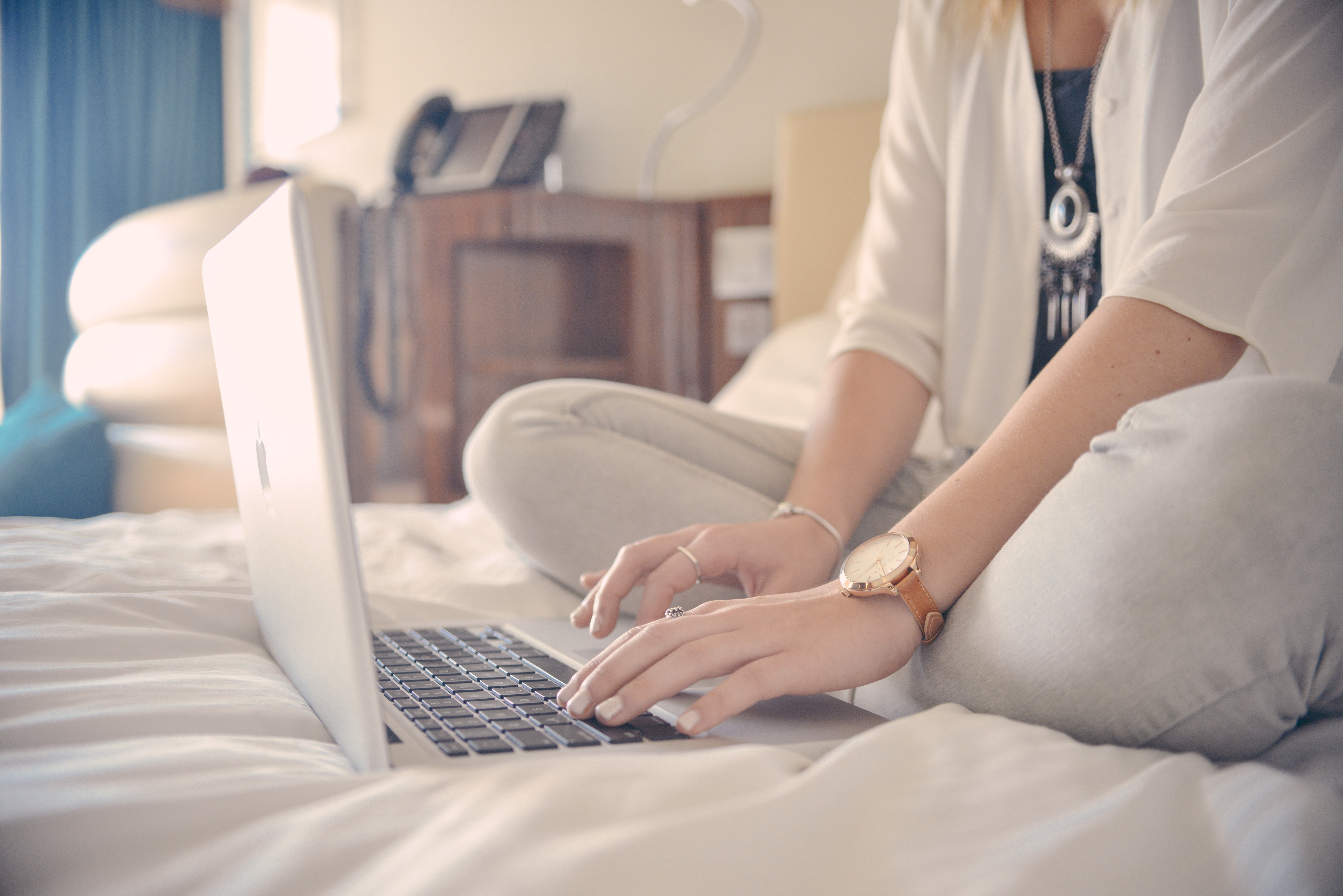 Image of a woman booking a Corporate Housing apartment on her laptop