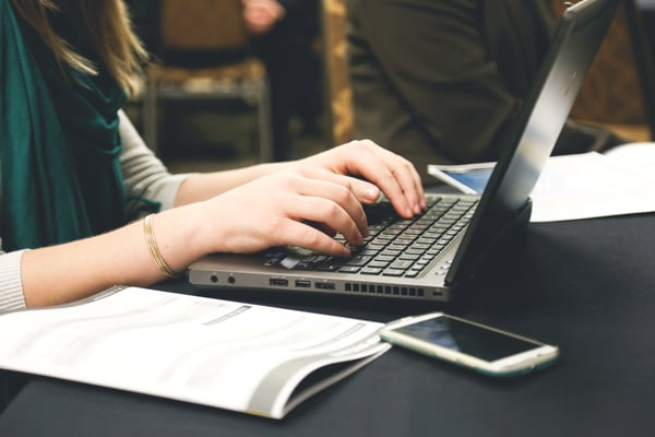 Image of someone typing on a laptop