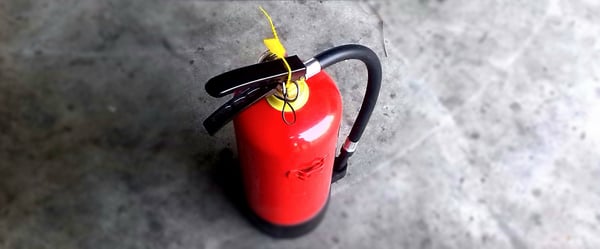 Image of a fire extinguisher, which is required in some Corporate Housing units