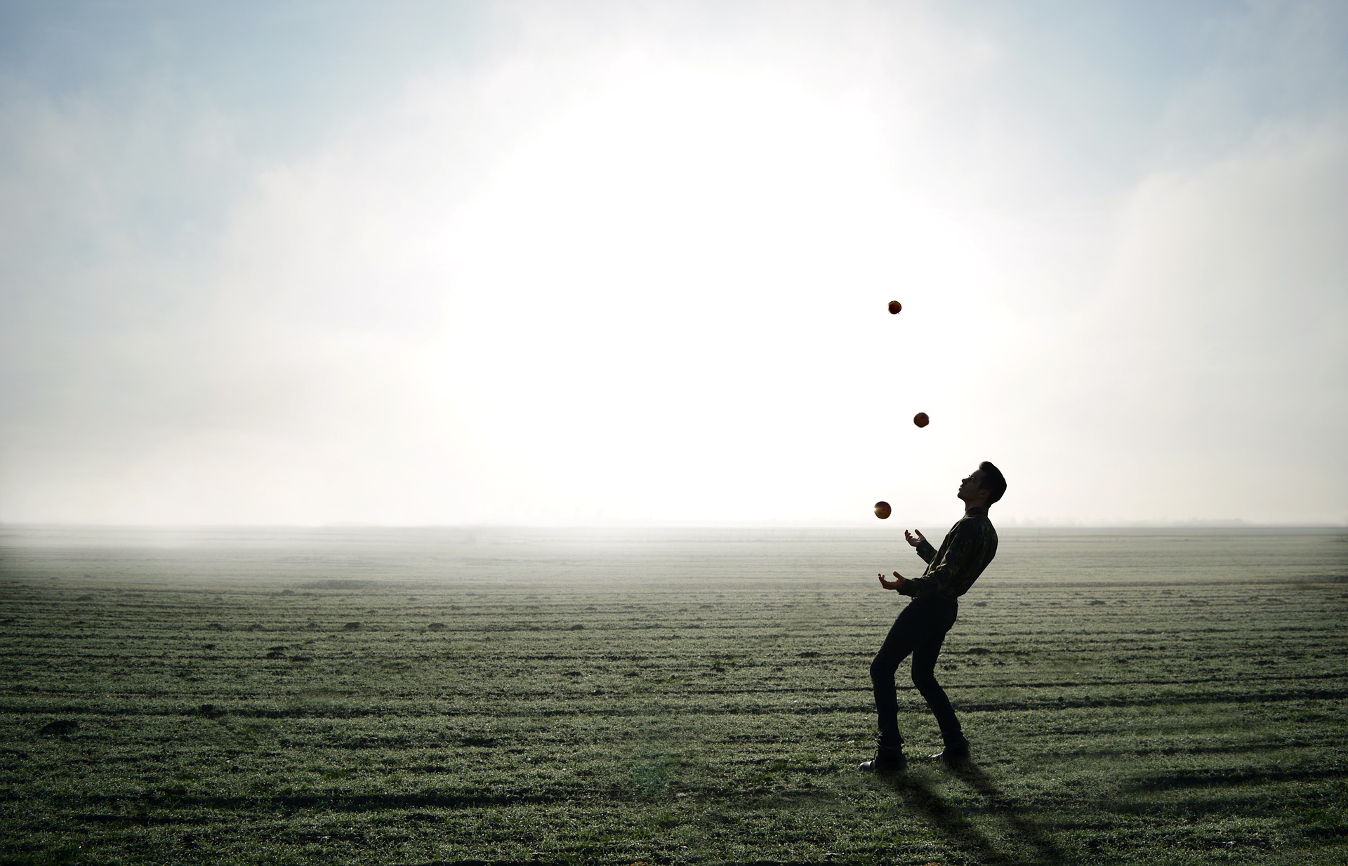 Image of a man juggling on a beach