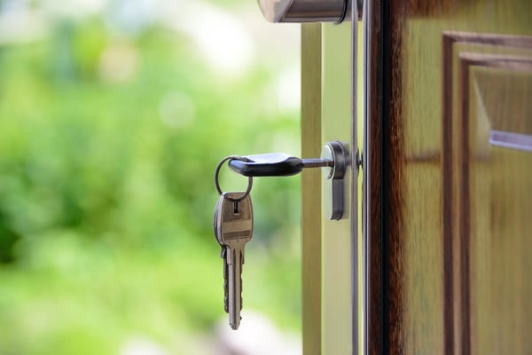 Image of keys in the keyhole of a door