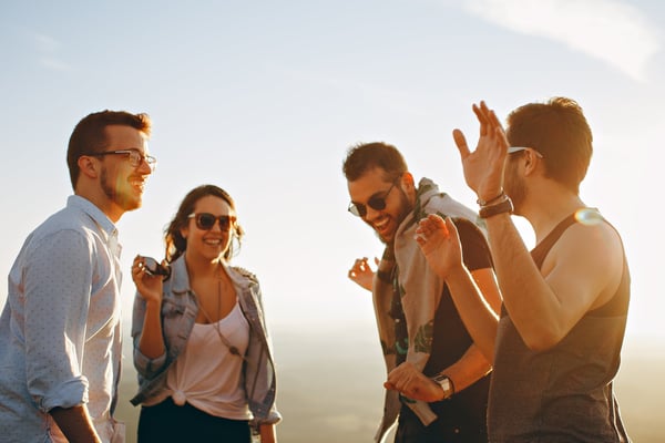 Image of four friends dancing