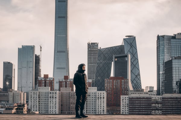Image of a man standing in front of the Beijing skyline