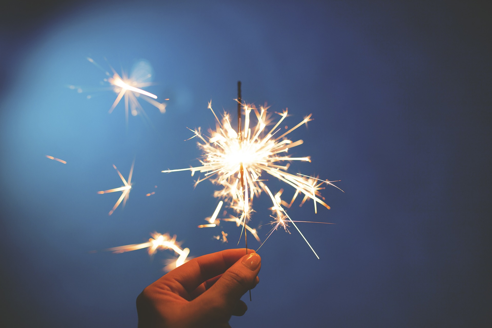 Image of a hand holding a sparkler