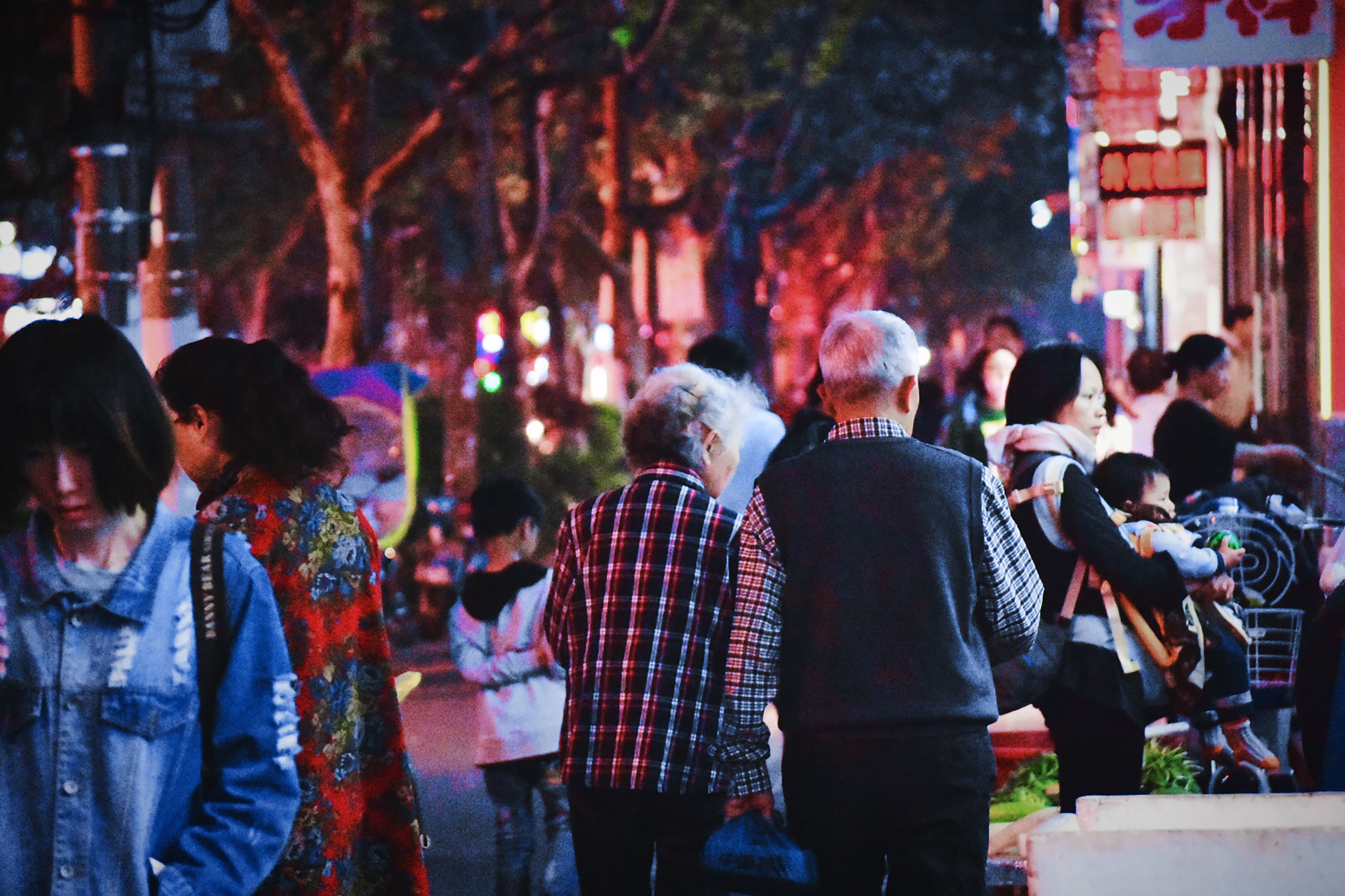 Image of people walking at night in China